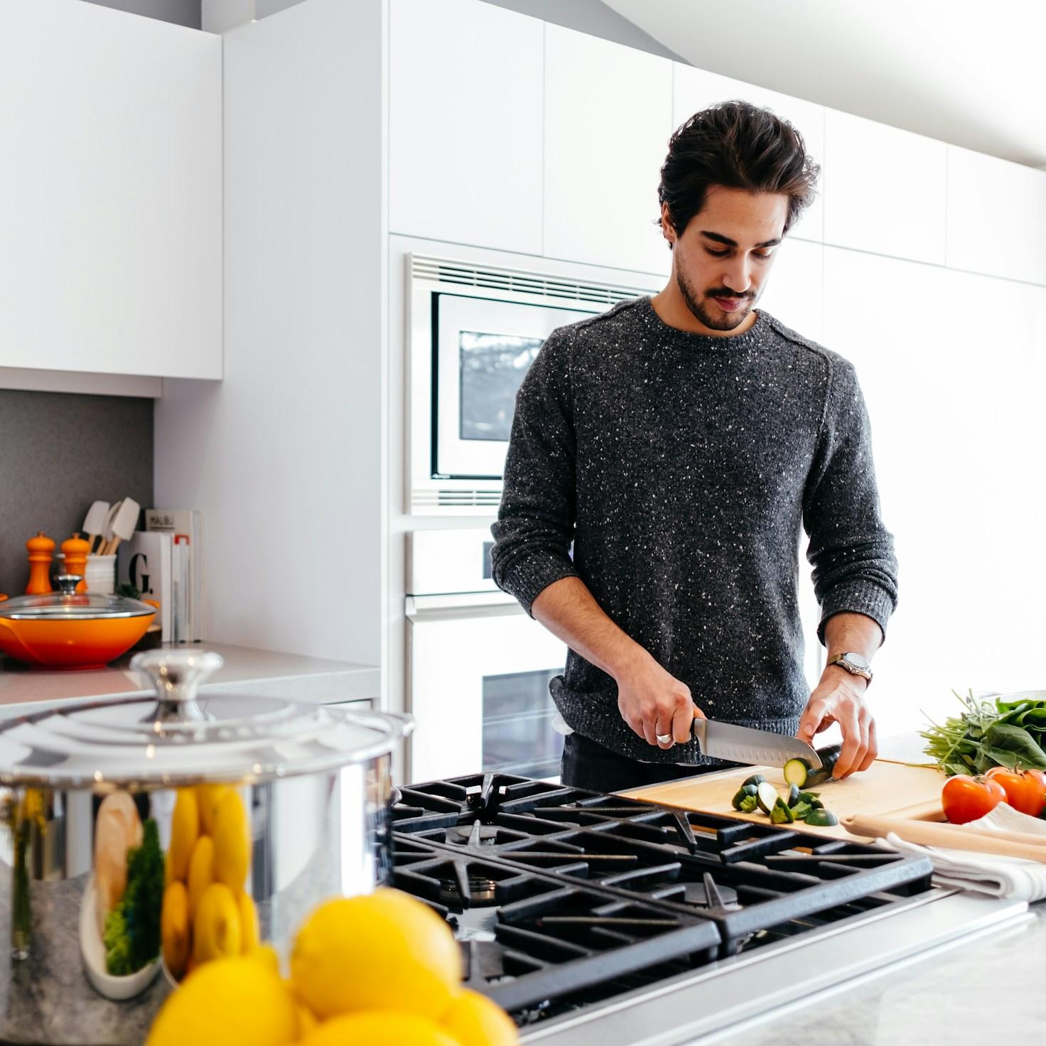 Community members collaborating in a modern kitchen space, sharing recipes and cooking techniques